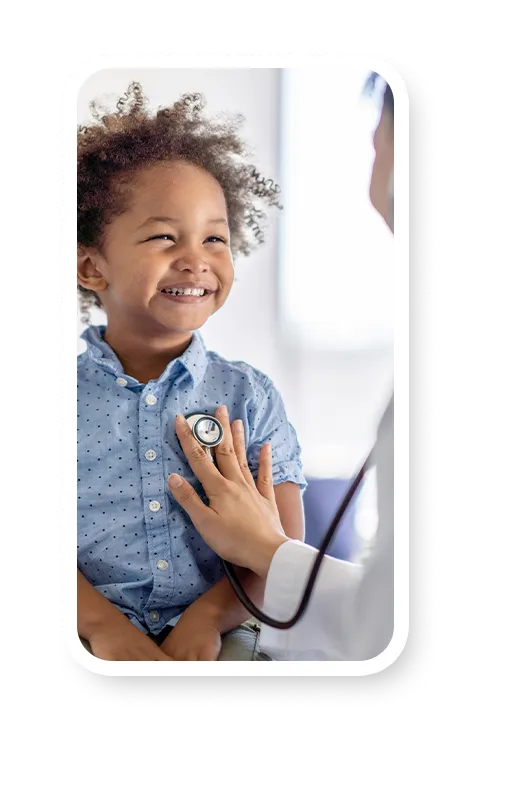 A doctor listening to a child's lungs to check for asthma symptoms.